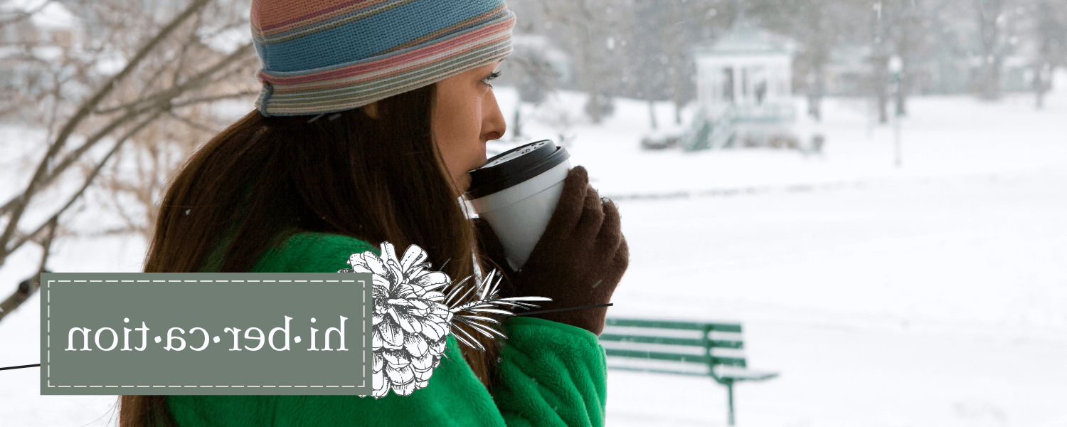 women in winter clothing drinking a hot beverage